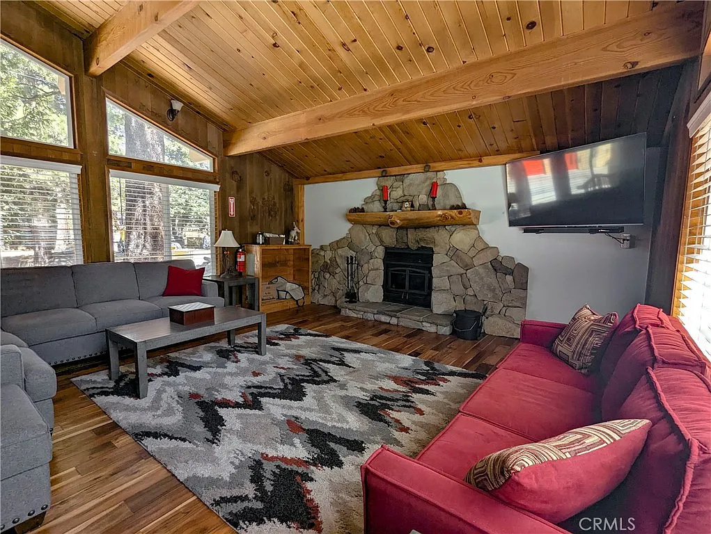 Living room centered on the dramatic stone fireplace
